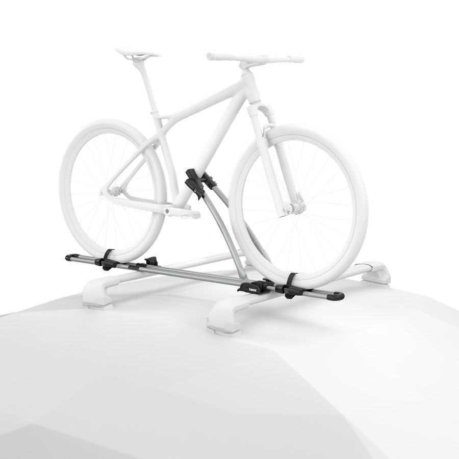 Ghosted illustration of a bicycle secured upright to an aluminum Thule FreeRide mounted on a vehicle roof.
